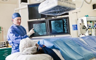Cath lab procedure with Interventionalist discussing the procedure with patient